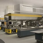 Commercial kitchen gas safety CP42: professional stainless steel commercial catering line with gas cooking ranges and ventilation canopy